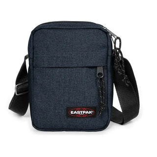 Eastpak The One Crossbodyväska - Triple Denim, fotad mot en vit bakgrund.
